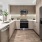 a kitchen with a stainless steel refrigerator
