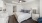 a bedroom with a bed and a fan