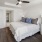 a bedroom with a bed and a fan