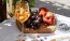 a board of fruit and a glass of wine
