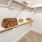 a white room with shelves and a bed
